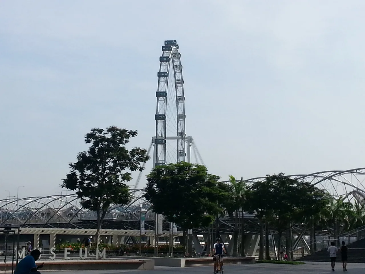 The Singapore Flyer rising over Marina Bay beside the Helix Bridge and ArtScience Museum